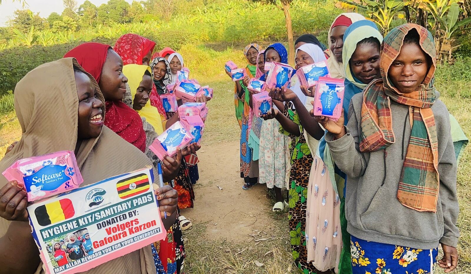 A line of girls holding sanitary pad kits they have just received