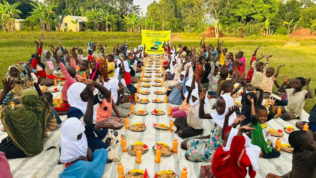 Children seated together for a weekly Juma meal