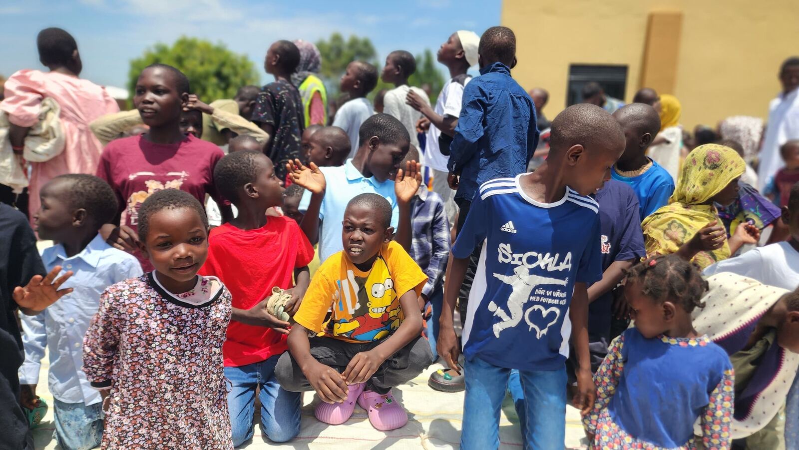 A group of children at a Good Will clothing and supplies distribution